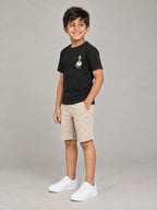 Little Kaavo kids crew tee in black, worn by a young boy, side view showing the fit